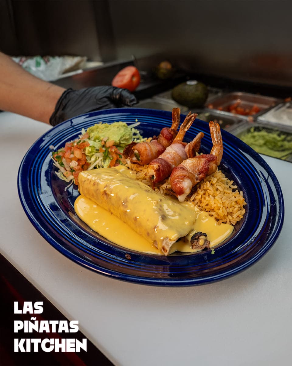 Cheese-Smothered Burrito with Bacon-Wrapped Shrimp — signature Mexican dish at Las Piñatas Kitchen in Tomball, TX